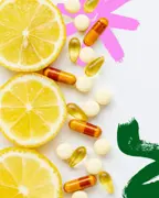 Lemon slices and supplement capsules arranged on a white background